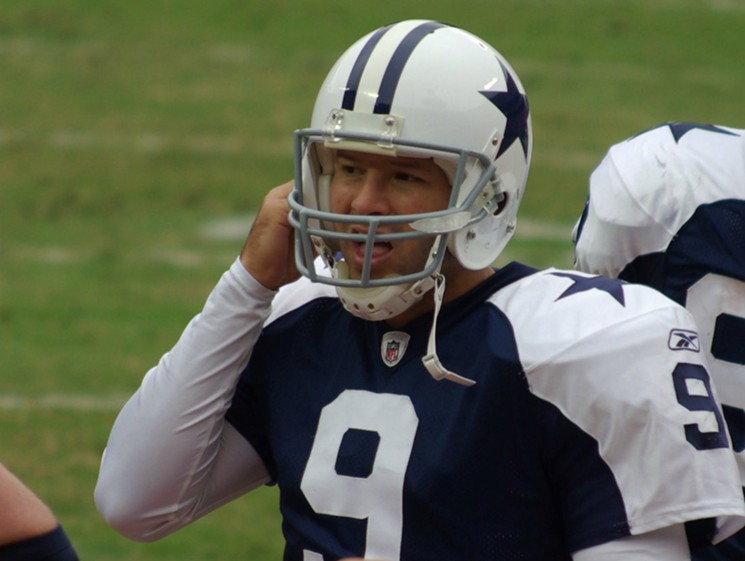 Tony Romo adjusts his chin strap during a game against the Kansas City Chiefs in 2009