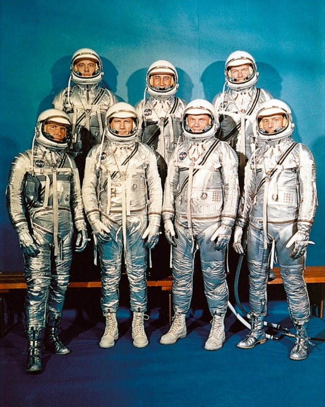 US Mercury program astronauts in their space suits pose for a family