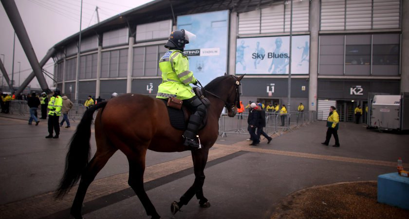 MANCHESTER ENGLAND- JANUARY 08 Riot police stand guard before the FA Cup Third Round match between Manchester City and Manchester United at the Etihad Stadium