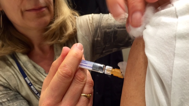 A nurse from the Saskatoon health region gives a patient a flu shot at a clinic in Saskatoon Nov. 13 2015