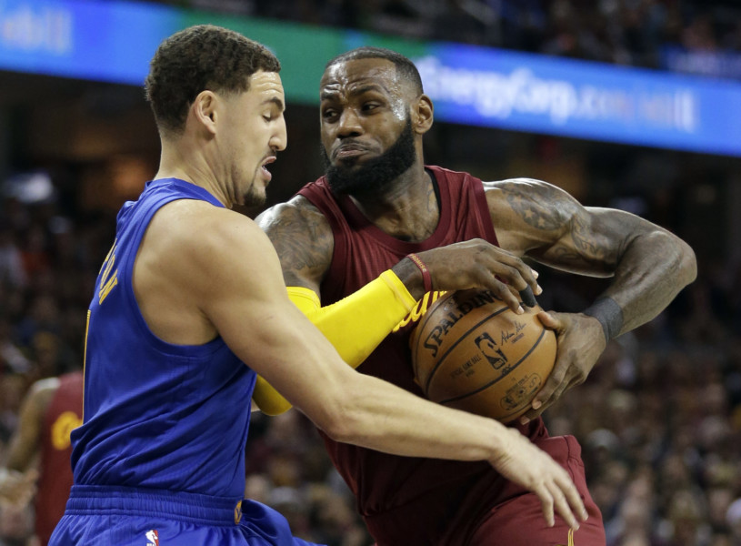 Cleveland Cavaliers&#039 Le Bron James right drives to the basket against Golden State Warriors&#039 Klay Thompson in the first half of an NBA basketball game Sunday Dec. 25 2016 in Cleveland. The Cavaliers won 109-108