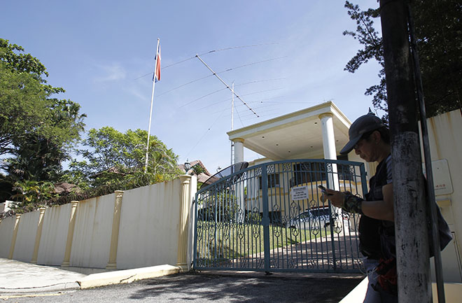 A journalist checks his phone outside North Korean Embassy in Kuala Lumpur Malaysia Feb. 25