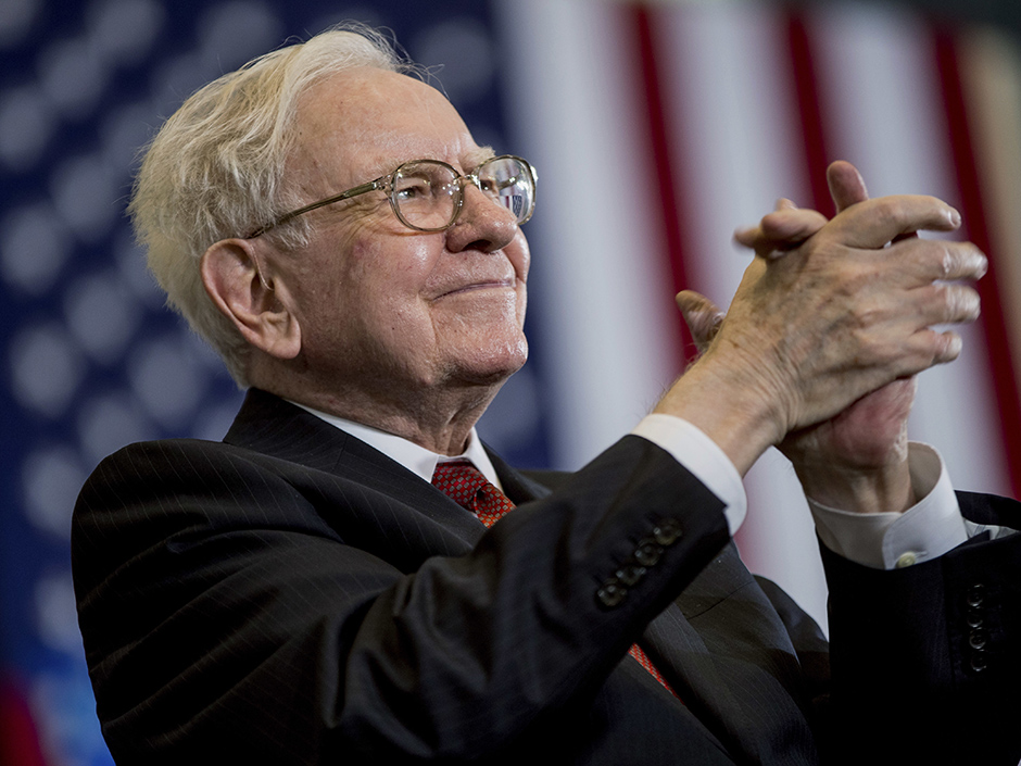 Berkshire Hathaway Chairman and CEO Warren Buffett applauds at a rally for Democratic presidential candidate Hillary Clinton in Omaha Neb. Buffett's company nearly quadrupled its investment in Apple to over 57 milli