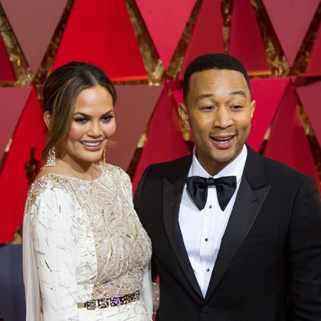 Chrissy Teigen goes full-on fangirl as she offers to rub Alicia Vikander's back during the Oscars