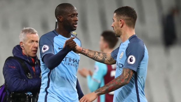 Yaya Toure of Manchester City celebrates with Aleksandar Kolorov of Manchester City after beating West Ham United 4-0 on Wednesday