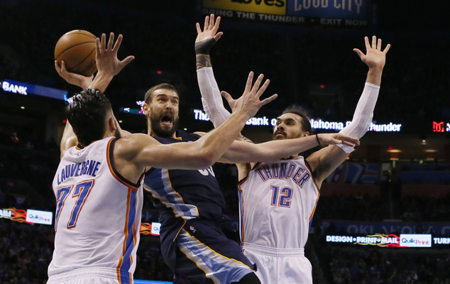 Memphis Grizzlies center Marc Gasol center shoots between Oklahoma City Thunder center Joffrey Lauvergne and center Steven Adams during the fourt