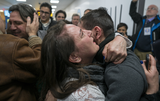 Family members who have just arrived from Syria embrace and are greeted by family who live in the United States upon their arrival at John F. Kennedy Interna