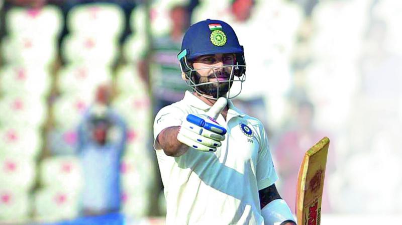 India’s captain Virat Kohli celebrates his century during the first day of the Test against Bangladesh in Hyderabad on Thursday