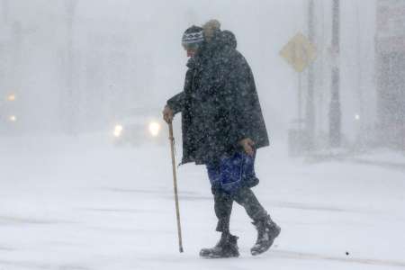 Todd Fike crosses the street during a snowstorm Thursday Feb. 9 2017 in Framingham Mass