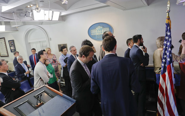 Reporters line up in hopes of attending a briefing in Press Secretary Sean Spicer's office at the White House in Washington Friday Feb. 24 2017. White House held an off camera briefing in Spicer's office where they selected who could attend. (AP