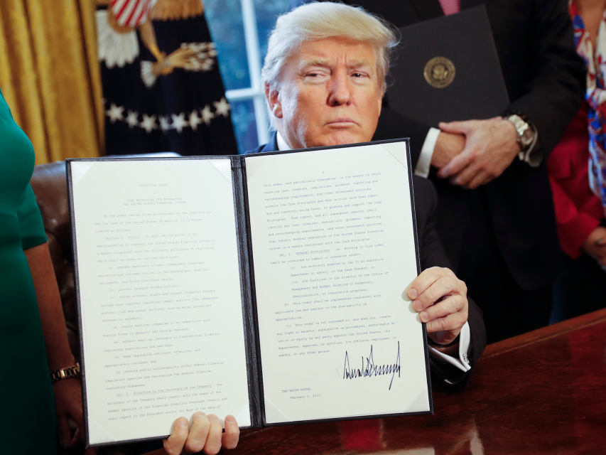 President Donald Trump signs an executive order in the White House