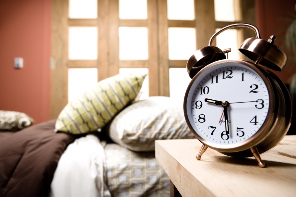 Alarm clock by bedside. Credit Thinkstock													  Jupiterimages