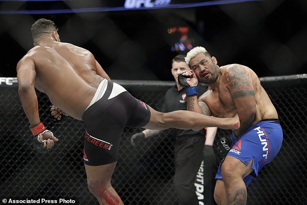 Alistair Overeem kicks Mark Hunt during a heavyweight mixed martial arts bout at UFC 209 Saturday