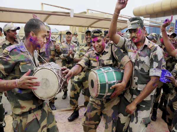 Border Security Force personnel dancing on the the eve of Holi celebrations at Akhaura integrated check-post in Agartala Tripura