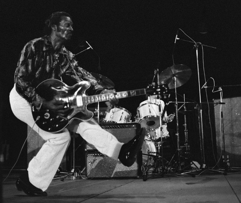 Chuck Berry produces his famous'duck walk in front of thousands gathered to see him perform