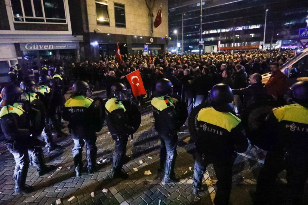 Demonstrators face Dutch riot police outside the Turkish consulate in Rotterdam Netherlands — REUTERS