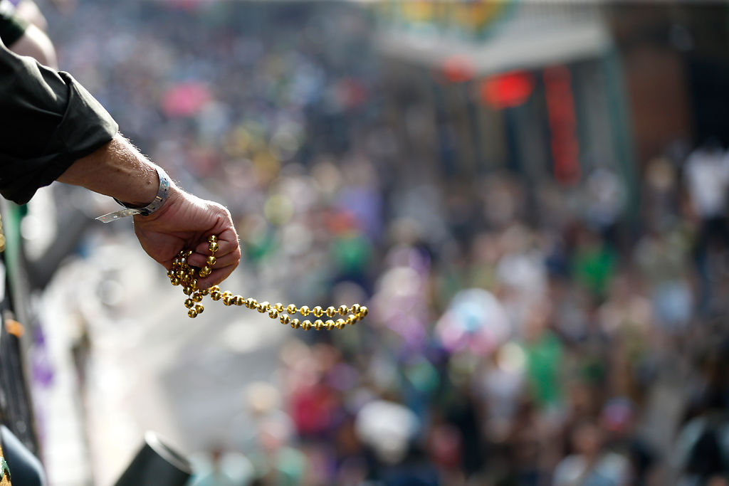 Revelers toss beads