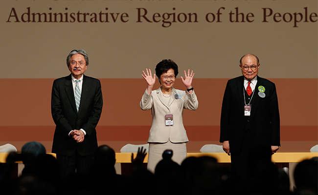 HONG KONG. Former Hong Kong Chief Secretary Carrie Lam center waves as she declares her victory in the chief executive election of Hong Kong while former Financial Secretary John Tsang left and retired judge Woo Kwok-hing stand with her in Hong Kong