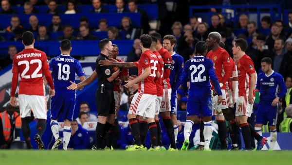 PLayers surround referee