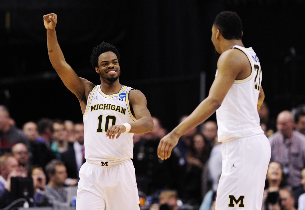 Mar 17 2017 Indianapolis IN USA Michigan Wolverines guard Derrick Walton Jr. and guard Zak Irvinn celebrate against the Oklahoma State Cowboys during the second half in the first round of the 2017 NCAA Tournament at Bankers Life Fieldhouse. Mand