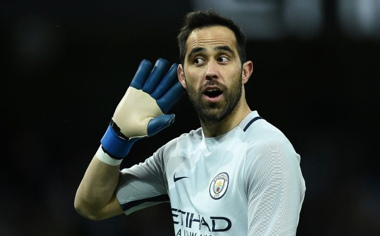 Manchester City's Chilean goalkeeper Claudio Bravo gestures to Huddersfield fans at the Etihad Stadium