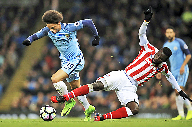 Manchester City's Leroy Sane and Stoke City's Mame Biram Diouf in action.- AP