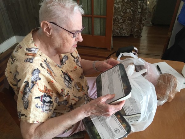 Meg Haskell | BDN Dottie Ham 80 of Bangor looks over her delivery from the Meals on Wheels program administered in the Bangor area by Eastern Area Agency on Aging. The meals are prepared locally frozen and delivered by volunteers who also check up