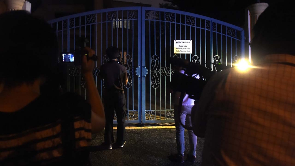 Members of the press gather in front of the gate of the North Korean embassy in Kuala