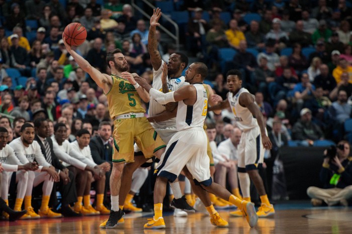 Irish junior guard Matt Farrell fends off two defenders during Notre Dame's 83-71 loss to West Virginia on Saturday at Key Bank Arena