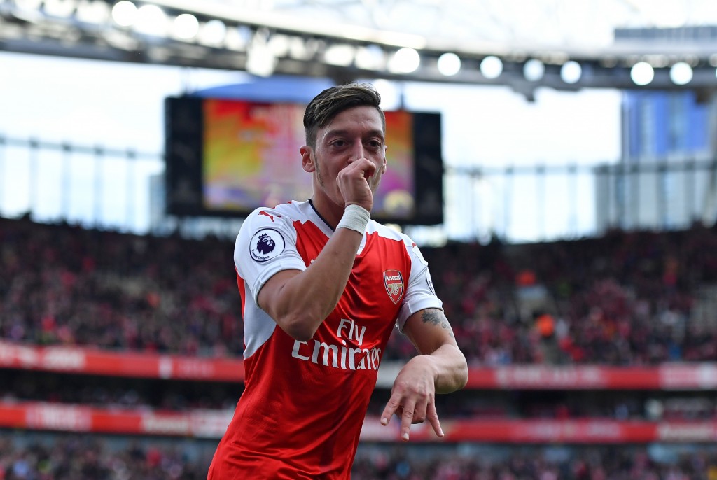 LONDON ENGLAND- OCTOBER 15 Mesut Ozil of Arsenal celebrates scoring his sides third goal during the Premier League match between Arsenal and Swansea City at Emirates Stadium