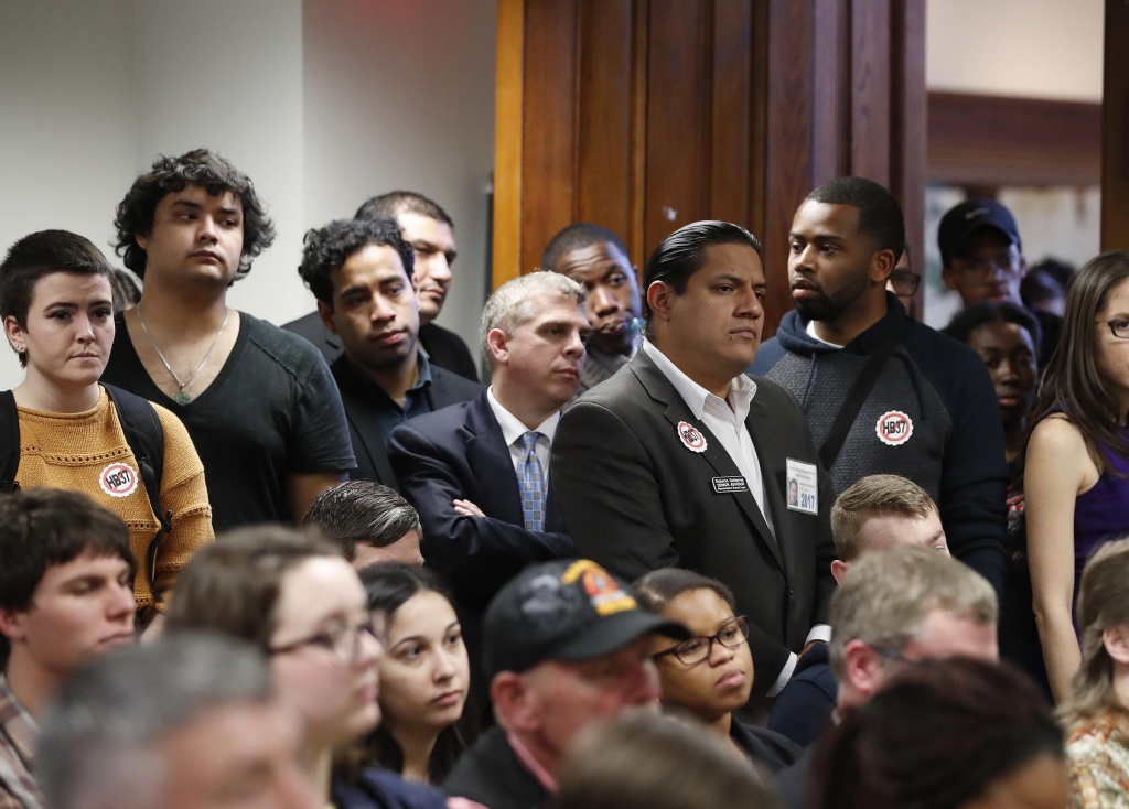 An overflow crowd gathers to hear discussion about a bill that would penalize colleges that protect undocumented immigrants during a meeting of the House Committee on Higher Education last month in Atlanta