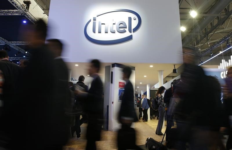 People walk under Intel logo at Mobile World Congress in Barcelona Spain