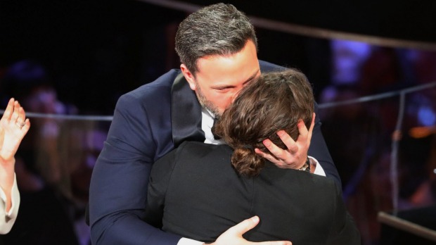 Casey Affleck hugs his brother Ben after winning the Best Actor Oscar