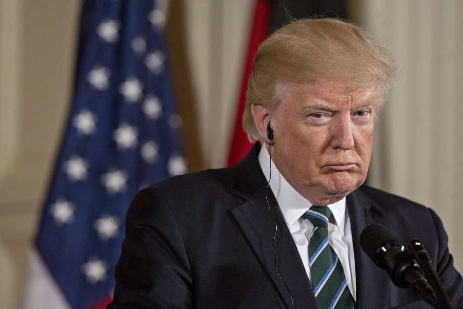 U.S. President Donald Trump listens during a news conference with Angela Merkel Germany's chancellor not