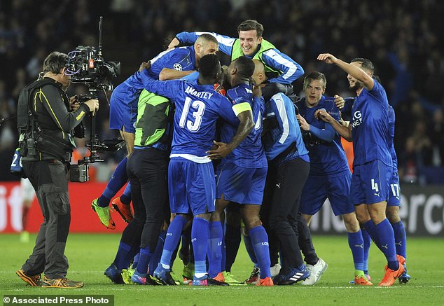 Leicester's players celebrate after the Champions League round of 16 second leg soccer match between Leicester City and Sevilla at the King Power Stadium in Leicester England Tuesday