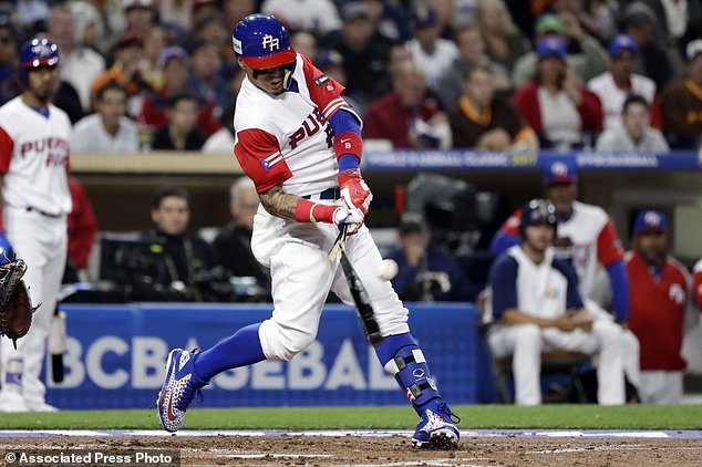 Puerto Rico's Javier Baez breaks his bat as he hits a single during the first inning of a second-round World Baseball Classic baseball game against the United States on Friday