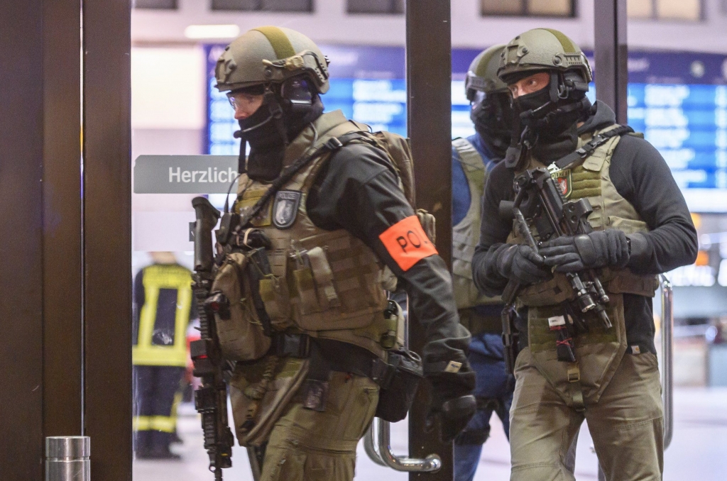 DUSSELDORF GERMANY- MARCH 09 Police and emergency workers stand outside the main railway station following what police described as an axe attack