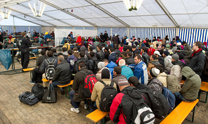 Refugees wait to be registered in a service tent at the train station in the Bavarian city of Passau southern Germany Monday Nov. 2 2015