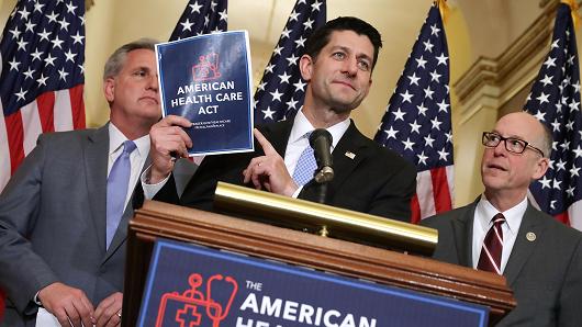 Speaker of the House Paul Ryan  holds up a copy of the American Health Care Act during a news conference with House Majority Leader Kevin Mc Carthy  and House Energy and Commerce Committee Chairman Greg Walden outside Ryan's