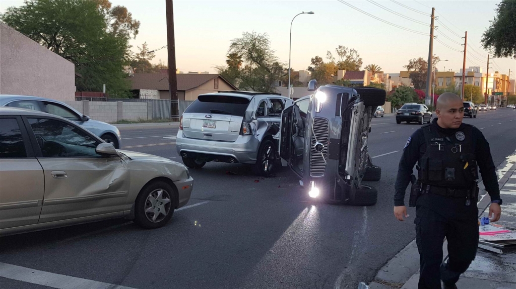 Image A self-driven Volvo SUV owned and operated by Uber Technologies Inc. is flipped on its side after a collision in Tempe