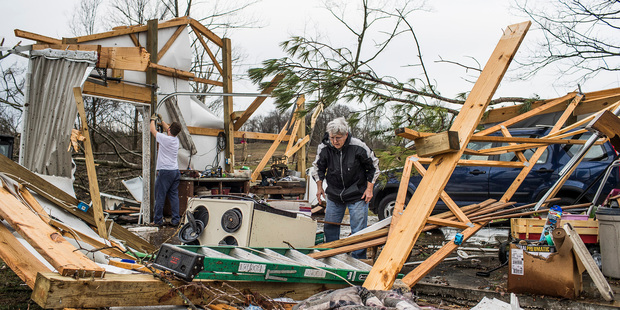 Loading Garlene Weaver sorts through debris after her house was hit by a strong storm in Warren County Kentucky