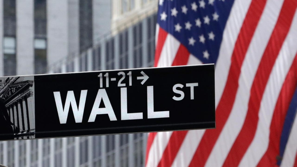 FILE- American flags fly at the New York Stock Exchange on Wall Street Monday