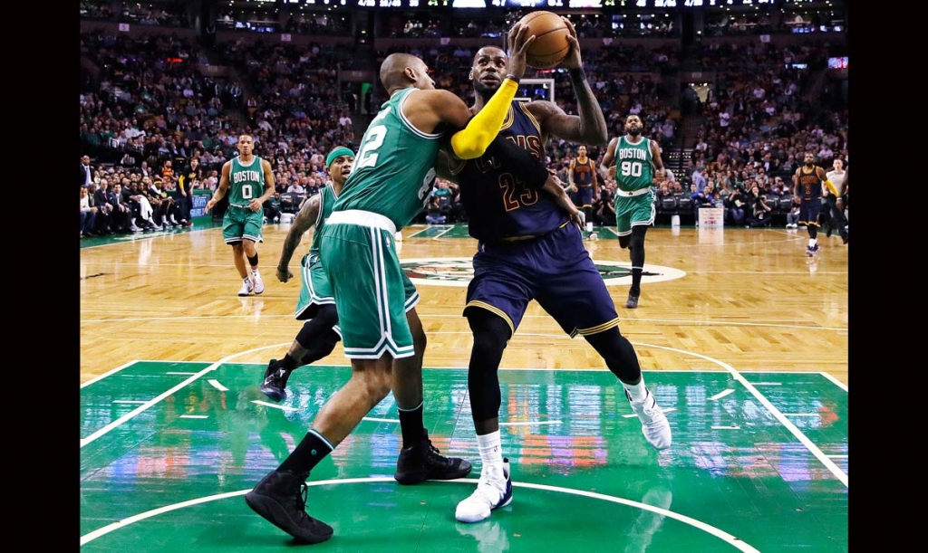 Cleveland Cavaliers forward Le Bron James right is fouled by Boston Celtics center Al Horford during the third quarter of an NBA basketball game in Boston Wednesday