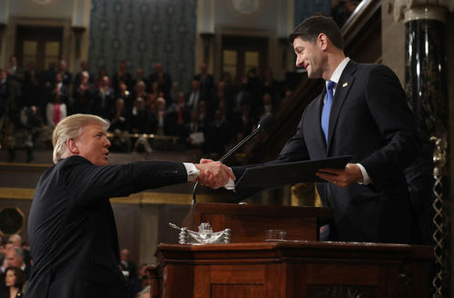 Two White men shake hands