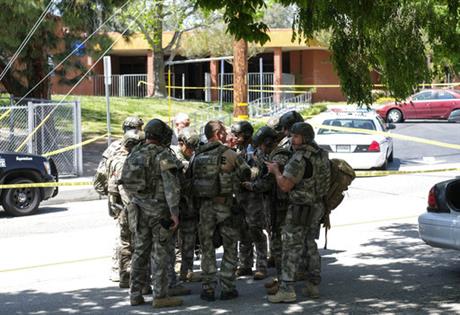 Police officers stand outside North Park School after a deadly shooting Monday