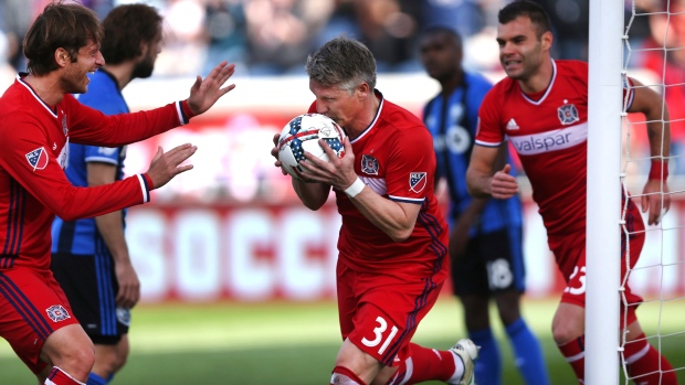 Chicago Fire midfielder Bastian Schweinsteiger kisses the ball after scoring a goal in the first half of a game against the Montreal Impact