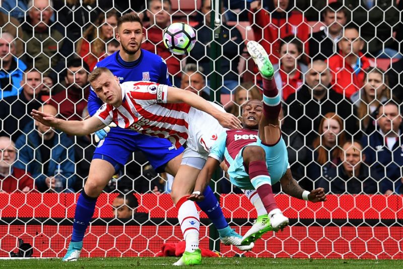 West Ham United's Andre Ayew tries an overhead shot which is saved by Stoke City's Jack Butland during their match in Stoke-on-Trent central England