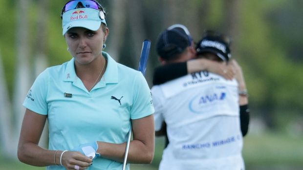 Lexi Thompson walks off the 18th green as So Yeon Ryu of South Korea celebrates with her caddie