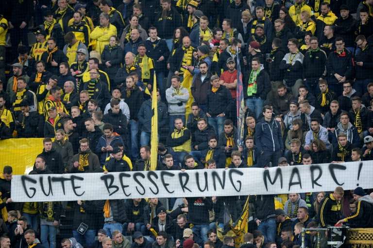 Fans hold a banner reading'Get well Marc ahead the UEFA Champions League 1st leg quarter-final football match BVB Borussia Dortmund v Monaco in Dortmund western Germany