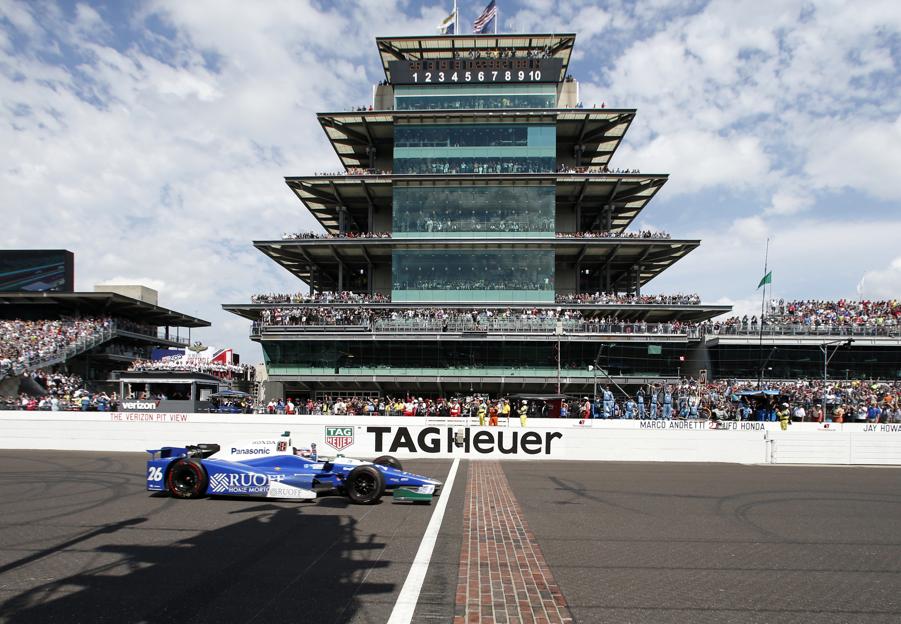 Takuma Sato of Japan celebrates as he crosses the Yard of Bricks to win the Indianapolis 500 auto race at Indianapolis Motor Speedway Sunday